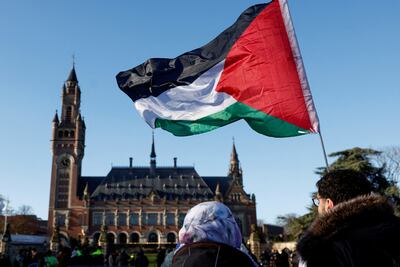 Protesters hold a Palestinian flag outside the ICJ during the South Africa-led case against Israel in January. Reuters