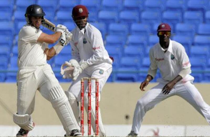 Ross Taylor droves a shot for New Zealand as Denesh Ramdin and Darren Sammy look on