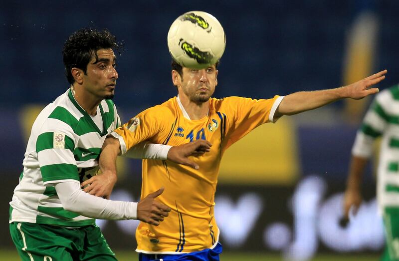 Al-Gharrafa's Iranian forward Mohammad Reza Khalatbari  (R) challenges Al-Ahli's Addul Aziz Karim during their Qatar Stars League football match in Doha on November 24, 2011. AFP PHOTO/KARIM JAAFAR
