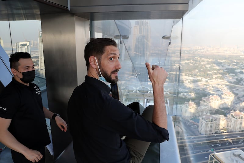 Jamie Goodwin going inside the Sky Glass Slide at Sky Views Dubai. Pawan Singh / The National