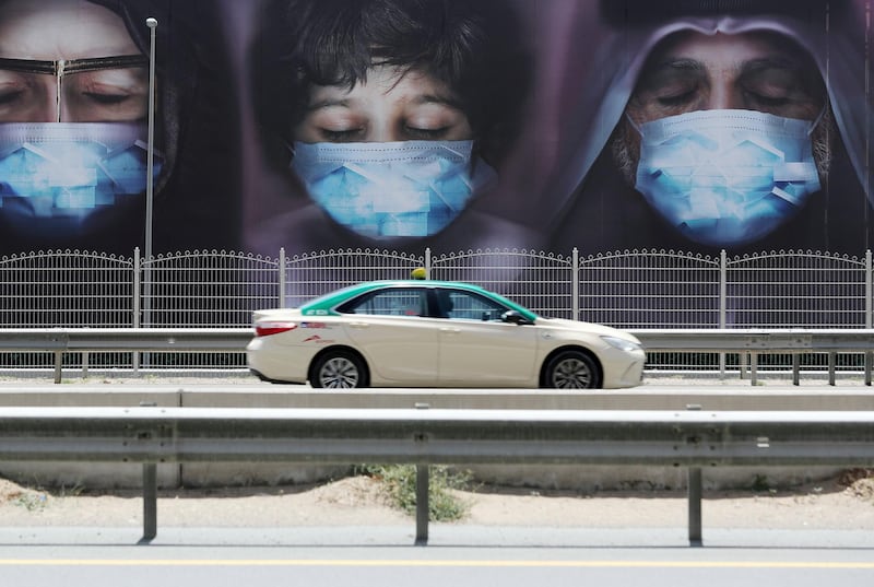 Dubai, United Arab Emirates - Reporter: N/A: A poster on Sheikh Zayed Road shows a family wearing facemasks tell people to Stay at home. Tuesday, April 14th, 2020. Dubai. Chris Whiteoak / The National