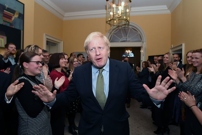 Mr Johnson is greeted by staff at No 10, Downing Street, after meeting Queen Elizabeth II and accepting her invitation to form a new government in December 2019. PA