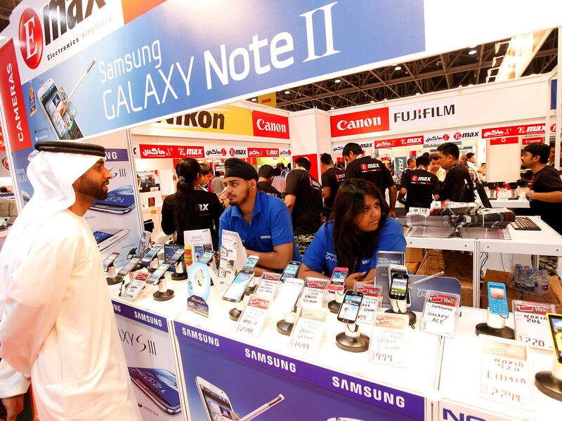 Dubai, United Arab Emirates- April, 03, 2013: Visitors browses the latest Mobile phones at the E-Max store during the Gitex Shoppers-2013 at the Dubai World Trade Centre in Dubai .  (  Satish Kumar / The National ) For Business