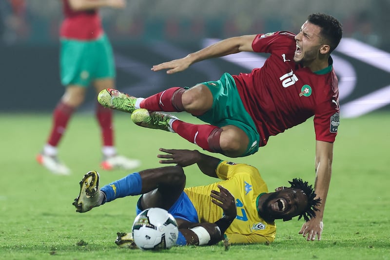 Morocco's midfielder Selim Amallah, top, is tackled by Gabon's midfielder Andre Biyogo Poko. AFP