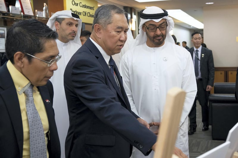 SINGAPORE, SINGAPORE - February 28, 2019: HH Sheikh Mohamed bin Zayed Al Nahyan, Crown Prince of Abu Dhabi and Deputy Supreme Commander of the UAE Armed Forces (R) looks at project during a visit to Mubadala's GLOBALFOUNDRIES semiconductor facility. Seen with Kay Chai Ang, Senior Vice President and General Manager for GlobalFoundries Asia and Europe Operations (2nd L), HE Dr Mohamed Maliki bin Osman, Senior Minister of State, Ministry of Defence & Ministry of Foreign Affairs (L) and HE Khaldoon Khalifa Al Mubarak, CEO and Managing Director Mubadala, Chairman of the Abu Dhabi Executive Affairs Authority and Abu Dhabi Executive Council Member (back L).
( Ryan Carter for the Ministry of Presidential Affairs )
---