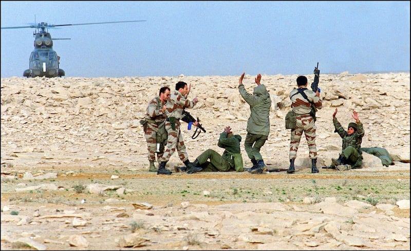 French special forces commandos capture 26 February 1991 somewhere in Iraqi desert Iraqi soldiers. Iraq's invasion of Kuwait 02 August 1990, ostensibly over violations of the Iraqi border, led to the Gulf War which began 16 January 1991. A U.S.-led multinational force expelled Iraq from Kuwait during the "Desert Storm" offensive and a cease-fire was signed 28 February 1991. (Photo by MIKE NELSON / AFP)