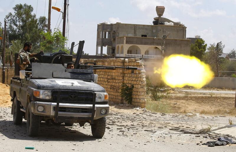 A fighters loyal to the internationally recognised Libyan Government of National Accord (GNA) shoots fires a truck-mounted gun during clashes with forces loyal to strongman Khalifa Haftar in the capital Tripoli's suburb of Ain Zara.  AFP