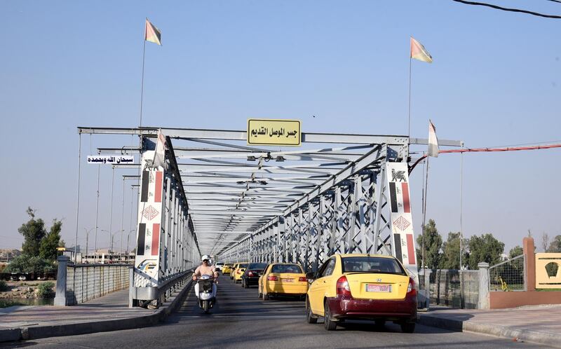Iraqis cross the old bridge at the Old city area, on the west side of Mosul city.  EPA