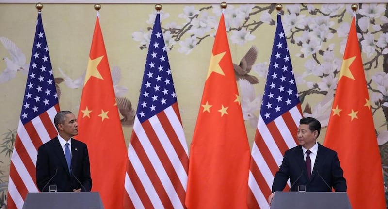 US President Barack Obama, left, and Chinese President Xi Jinping in Beijing in November. The Obama administration's policy to 'pivot' resources to Asia is a thought to be an attempt to constrain China. Feng Li / Getty Images