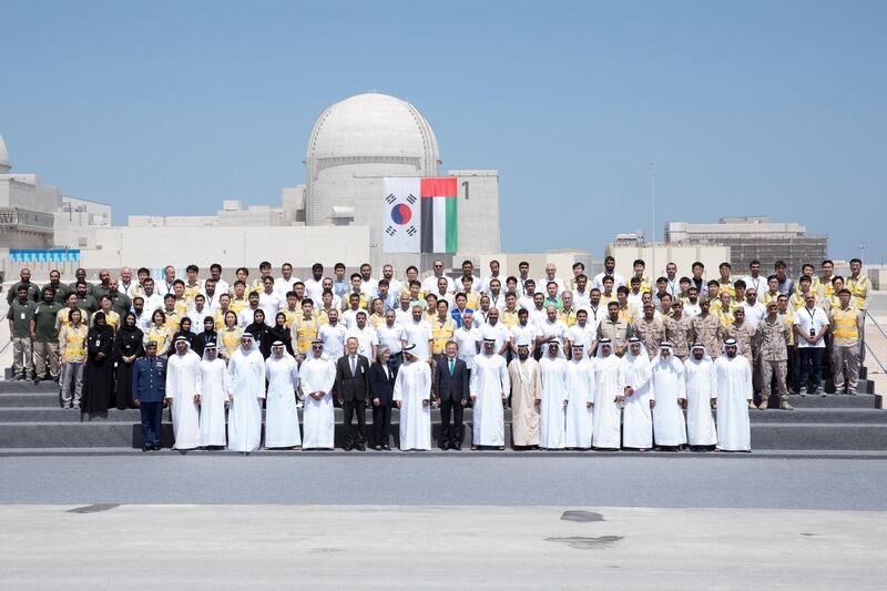 AL DHAFRA, ABU DHABI, UNITED ARAB EMIRATES - March 26, 2018: Front row:  HH Sheikh Diab bin Tahnoon bin Mohamed Al Nahyan (R), Mubarak bin Garran Al Mansouri (3rd R), HH Sheikh Abdullah bin Zayed Al Nahyan, UAE Minister of Foreign Affairs and International Cooperation (4h R), HH Sheikh Hamed bin Zayed Al Nahyan, Chairman of the Crown Prince Court of Abu Dhabi and Abu Dhabi Executive Council Member (5th R), HE Mohamed Al Hammadi, CEO Emirates Nuclear Energy Corporation (ENEC) (6th R), HH Sheikh Nahyan Bin Zayed Al Nahyan, Chairman of the Board of Trustees of Zayed bin Sultan Al Nahyan Charitable and Humanitarian Foundation (7th R), HH Sheikh Tahnoon bin Mohamed Al Nahyan, Ruler's Representative in Al Ain Region (8th R), HH Sheikh Mohamed bin Zayed Al Nahyan Crown Prince of Abu Dhabi Deputy Supreme Commander of the UAE Armed Forces (9th R), HE Moon Jea-In, President of South Korea (10th R), HH Sheikh Hamdan bin Zayed Al Nahyan, Ruler’s Representative in Al Dhafra Region (11th R), HH Lt General Sheikh Saif bin Zayed Al Nahyan, UAE Deputy Prime Minister and Minister of Interior (14th R), HH Sheikh Diab bin Zayed Al Nahyan (15th R), HE Khaldoon Khalifa Al Mubarak, CEO and Managing Director Mubadala, Chairman of the Abu Dhabi Executive Affairs Authority and Abu Dhabi Executive Council Member (16th R), HE Suhail bin Mohamed Faraj Faris Al Mazrouei, UAE Minister of Energy (17th R) and HE Mohamed Mubarak Al Mazrouei, Undersecretary of the Crown Prince Court of Abu Dhabi (18th R), attend the Unit One Construction Completion Celebration at Barakah Nuclear Energy Plant. Seen with Emirates Nuclear Energy Corporation employees. 

( Hamad Al Mansoori for The Crown Prince Court - Abu Dhabi )
---