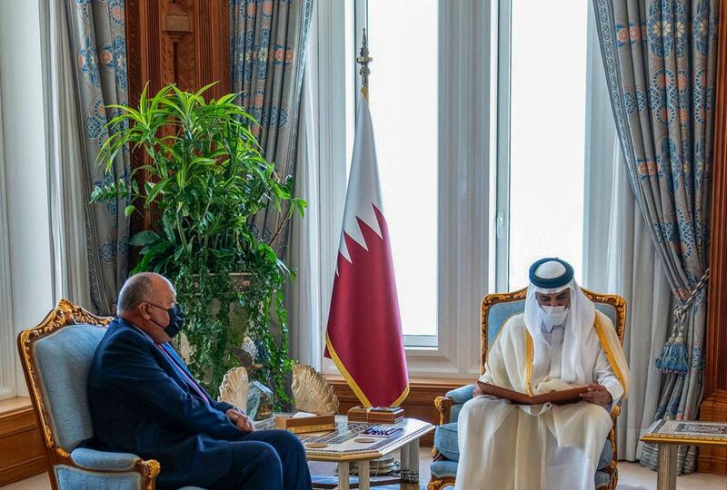A handout picture released by the Qatar News Agency (QNA) on June 15, 2021 shows Qatar's ruler Emir Sheikh Tamim bin Hamad Al-Thani (R) reading a letter from the Egyptian president, delivered by Egypt's Foreign Minister Sameh Shoukry (L), in Doha.  RESTRICTED TO EDITORIAL USE - MANDATORY CREDIT "AFP PHOTO / QATAR NEWS AGENCY " - NO MARKETING NO ADVERTISING CAMPAIGNS - DISTRIBUTED AS A SERVICE TO CLIENTS
 / AFP / Qatar News Agency / - /  RESTRICTED TO EDITORIAL USE - MANDATORY CREDIT "AFP PHOTO / QATAR NEWS AGENCY " - NO MARKETING NO ADVERTISING CAMPAIGNS - DISTRIBUTED AS A SERVICE TO CLIENTS
