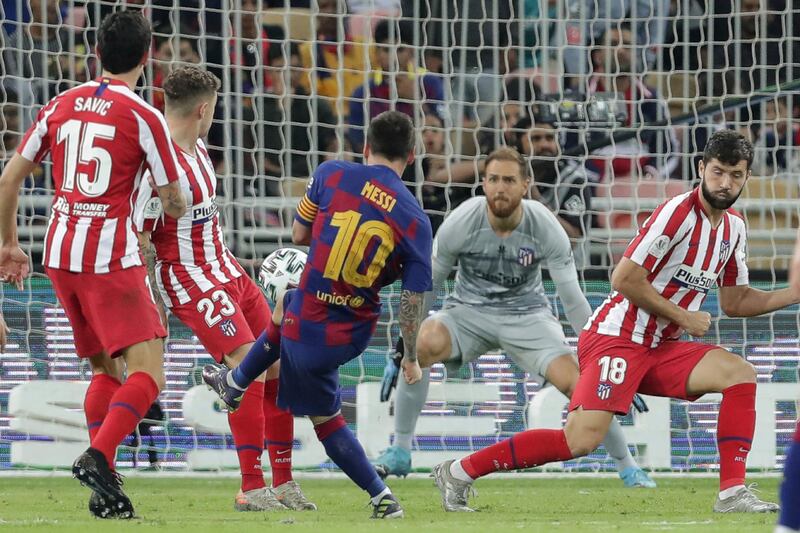 Barcelona's Lionel Messi, centre, scores his side's opening goal. AP