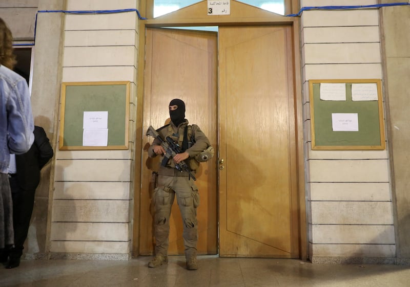 A soldier stands guard as ballots are counted at the Justice Palace. Reuters