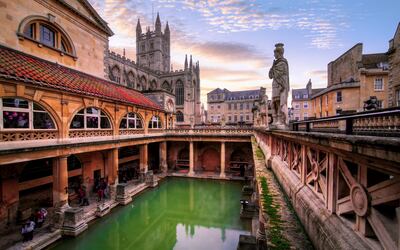 The Roman Baths in Bath, Somerset, with Bath Abbey in the background. Getty Images
