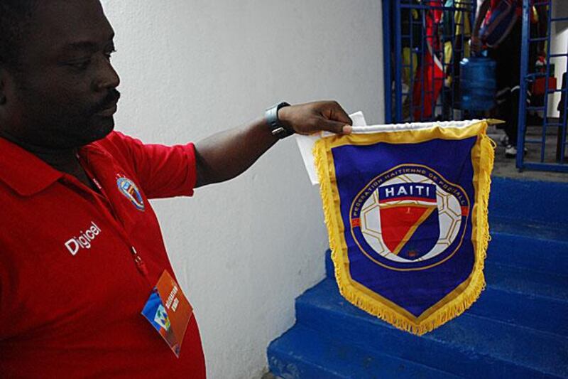A Haitian official holds the Haitian pennant to be given to the US Virgin Islands' captain at kick-off.
