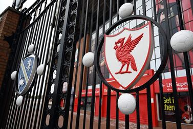 A picture shows the locked gate and emblem at Liverpool's Anfield stadium in Liverpool, northwest England. The Premier League, along with almost all football leagues, has been suspended due to the coronavirus pandemic. AFP