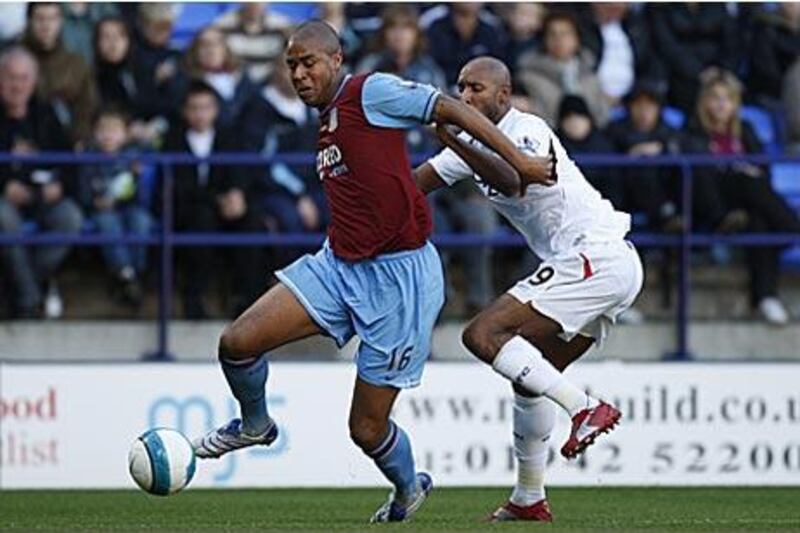 Zat Knight, left, is pictured for Aston Villa against Bolton in 2007. He signed for the Wanderers yesterday.