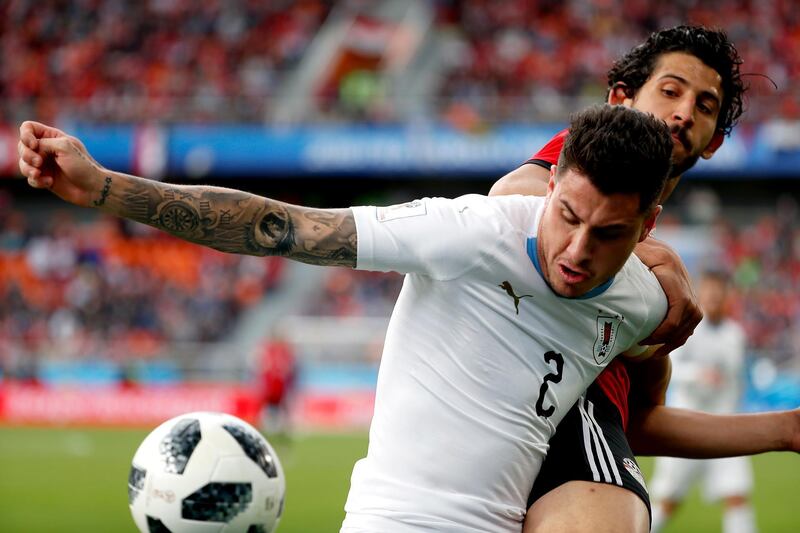 Uruguay's Jose Gimenez of Uruguay, front, and Egypt's Ahmed Hegazy in action during their group A match at the 2018 FIFA World Cup at the Yekaterinburg Arena in Yekaterinburg, Russia, on June 15, 2018. Francis R. Malasig / EPA