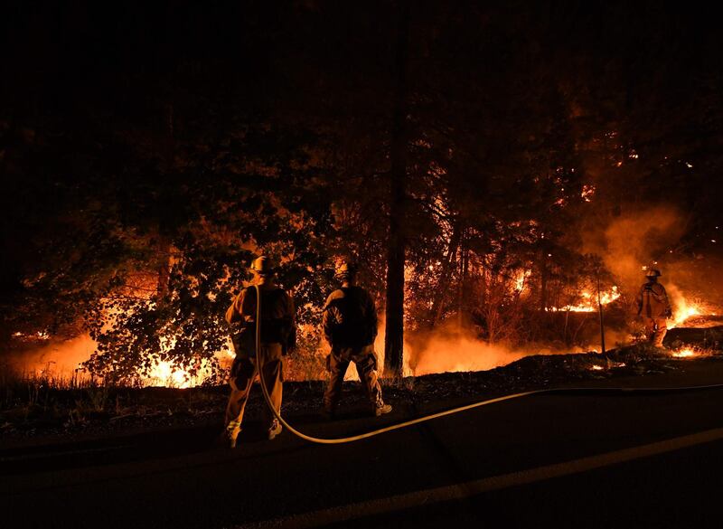 Firefighters try to contain flames from the Carr fire as it spreads towards the town of Douglas City near Redding, California. AFP PHOTO / Mark RALSTON