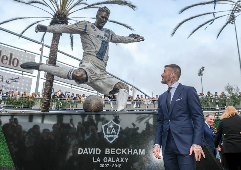 Former LA Galaxy MLS soccer midfielder David Beckham looks at a statue of himself at Legends Plaza in front of Dignity Health Sports Park in Carson, Calif., Saturday, March 2, 2019. (AP Photo/Ringo H.W. Chiu)
