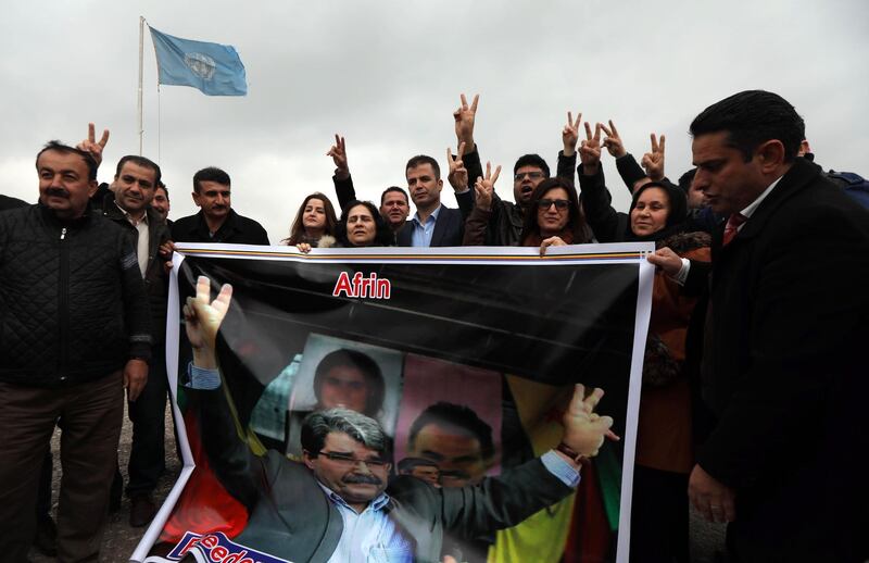 Kurdish protesters hold a poster bearing a portrait of Saleh Muslim, the former co-chair of the Democratic Union Party (PYD), as they gather to demonstrate against his arrest, outside the United Nations office in the northern Iraqi city of Arbil, the capital of the autonomous Kurdistan region, on February 26, 2018. 
Saleh Muslim, was arrested late on February 25, 2018 in the Czech capital Prague, according to a statement by a coalition of political parties that includes the PYD. / AFP PHOTO / SAFIN HAMED