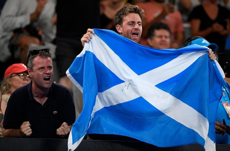 Supporters of Britain's Andy Murray wave a Scottish flag during his first round match against Spain's Roberto Bautista Agut at the Australian Open tennis championships in Melbourne, Australia. AP Photo