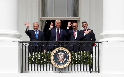 Israel's former prime minister Benjamin Netanyahu, former US president Donald Trump, Bahrain's Foreign Minister Abdullatif Al Zayani and the UAE’s Foreign Minister Abdullah bin Zayed wave from the White House balcony after a signing ceremony for the Abraham Accords. Reuters