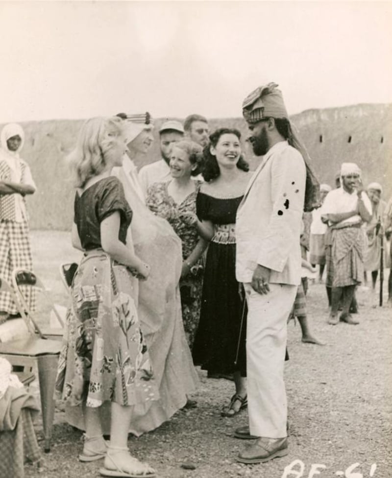 Wendell Phillips (center, in robes) is made a sheikh of the Bal Harith tribe and given the name Hussein Ali, at a farewell party for the expedition in Beihan given by Sherif Hussein. 