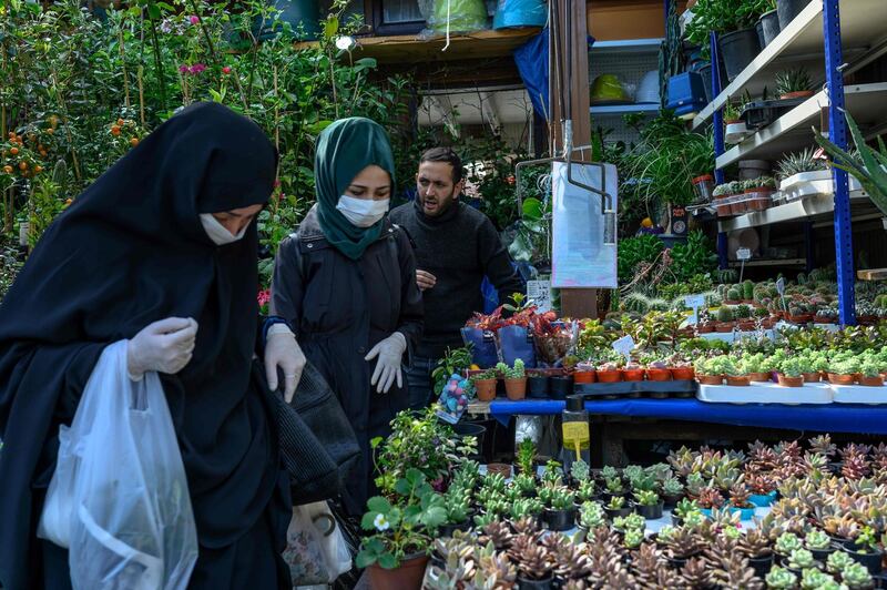 Women checks spring flowers in a garden market, at Eminonu, in Istanbul. AFP