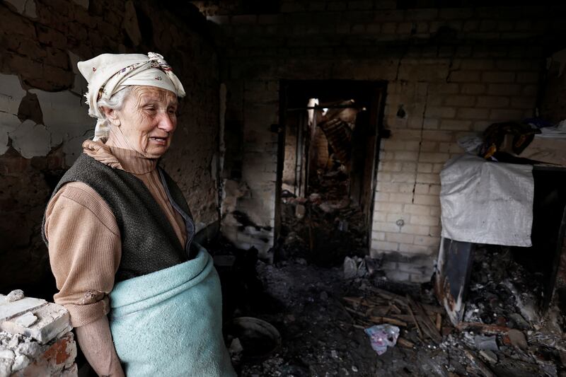 Hanna Selivon, 77, surveys what remains of her house, which she says was destroyed by Russian shelling on the outskirts of Chernihiv, Ukraine. Reuters