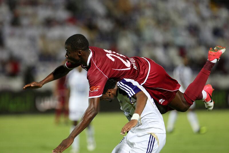 AL AIN , UNITED ARAB EMIRATES Ð Oct 14 : Papa Waigo ( no 21 in maroon ) of Al Wahda and Fawzi Fayez ( no 21 in white ) of Al Ain in action during the Etisalat Cup round 3 football match between Al Wahda vs Al Ain at Tahnoun Bin Mohammed Stadium in Al Ain. ( Pawan Singh / The National ) For Sports. Story by Amit