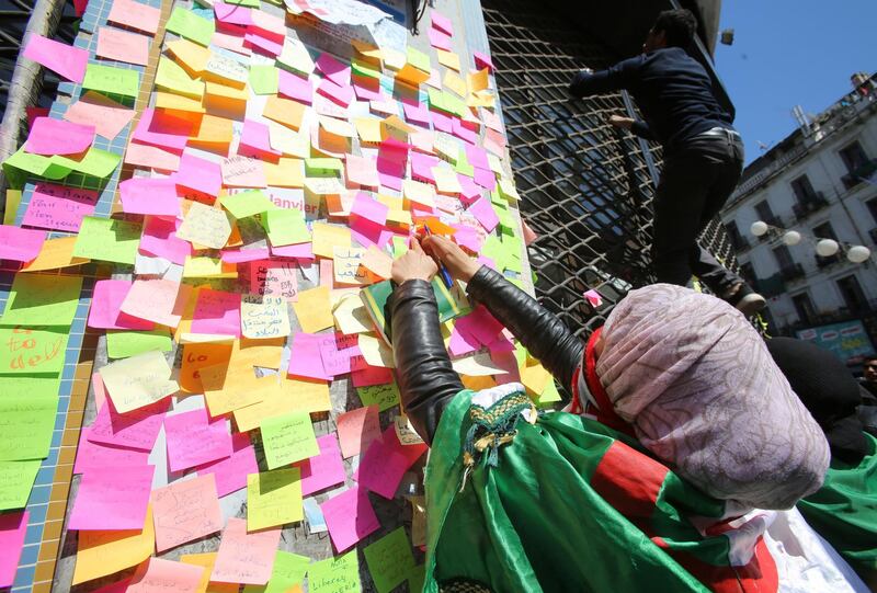 People write messages on sticky notes during a protest demanding immediate political change in Algiers, Algeria. Reuters
