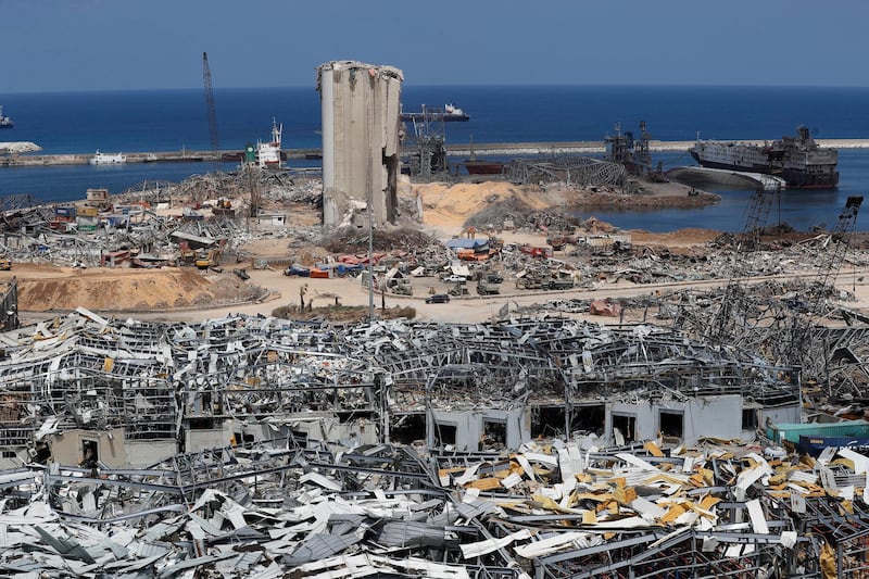 FILE - This Aug. 19, 2020 file photo, shows the the scene of the Aug. 4 explosion that hit the seaport of Beirut, Lebanon. Interpol issued a wanted notice for two Russians and a Portuguese man over explosive material that had been shipped to Beirut and stored at the cityâ€™s port for six years until it exploded in August. The state-run National News Agency reported on Tuesday, Jan. 12, 2021, that the Interpol-issued Red Notices were for the owner and captain of the Rhosus, the ship that carried the 2,750 tons of ammonium nitrate to Lebanon in 2013, as well as a Portuguese nitrate trader who visited the portâ€™s warehouse in Beirut in 2014 where the material was stored. (AP Photo/Hussein Malla, File)