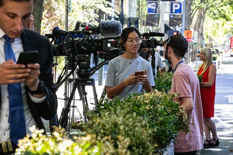 Members of the media wait outside the car park of the office of the legal team of Serbian tennis player Novak Djokovic. Getty Images