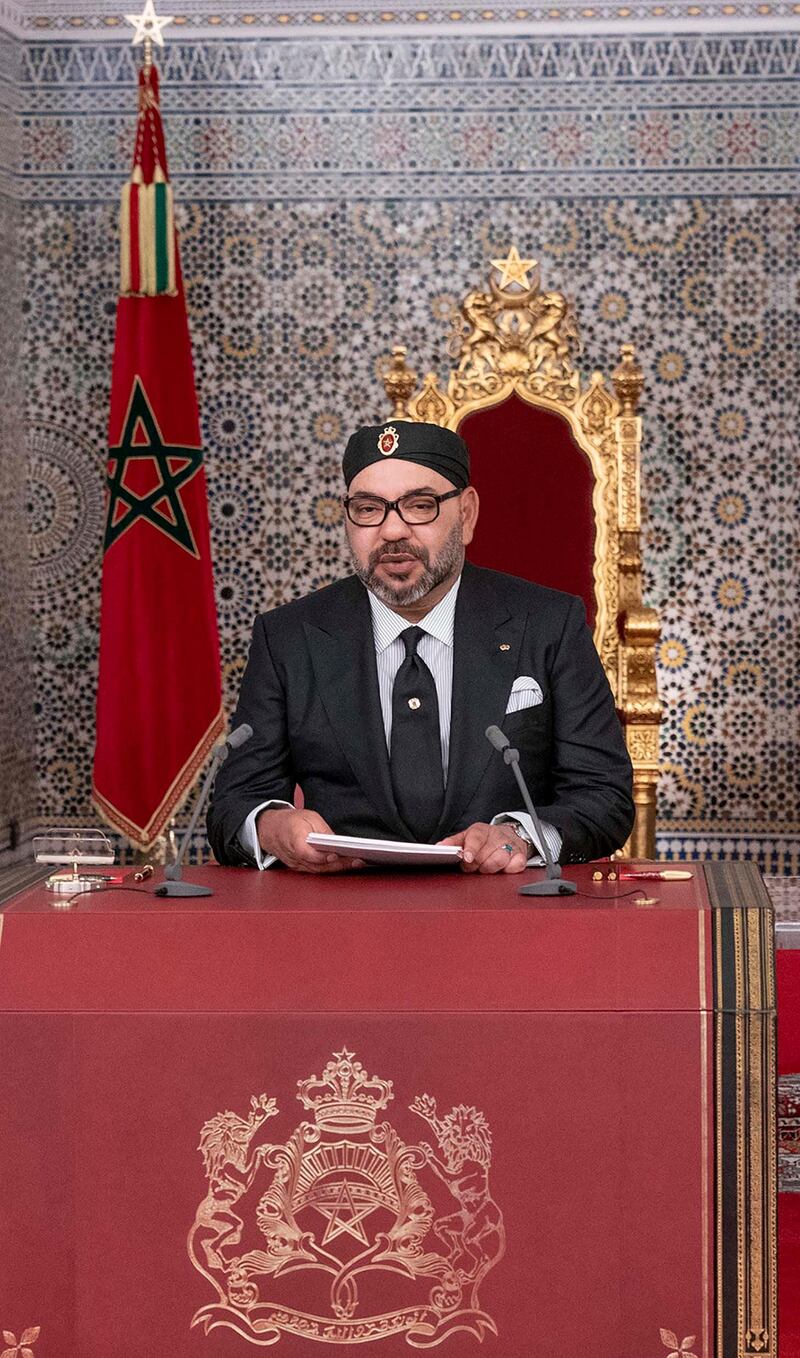 This handout picture provided by the Moroccan Royal Palace on July 29, 2019 shows Morocco's King Mohammed VI (C) delivering a speech marking the 20th anniversary of his accession to the throne, with his brother Prince Moulay Rachid (R) and son Prince Moulay Hassan (L) seated alongside him, in the northern city of Tetouan overlooking the Mediterranean. (Photo by - / MAP / AFP) / == RESTRICTED TO EDITORIAL USE - MANDATORY CREDIT "AFP PHOTO /HO/ MOROCCAN ROYAL PALACE" - NO MARKETING NO ADVERTISING CAMPAIGNS - DISTRIBUTED AS A SERVICE TO CLIENTS ==