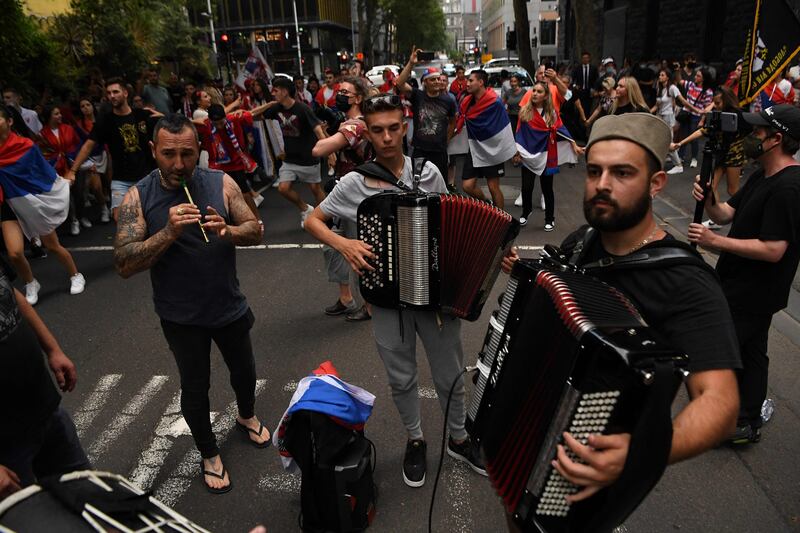 Members of the local Serbian community play music and dance outside the legal offices where Serbia's tennis champion Novak Djokovic is in with his legal team in Melbourne.  AFP
