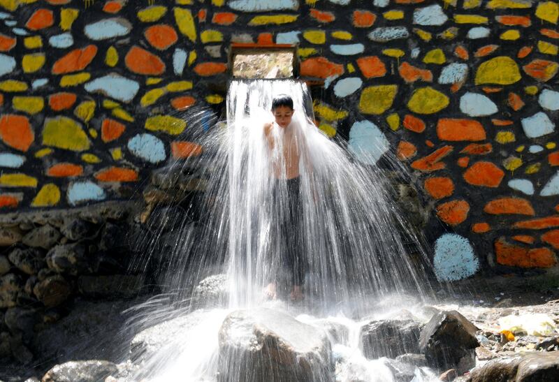 An Afghan boy cools off under a waterfall in the Paghman district in Kabul. Mohammad Ismail / Reuters