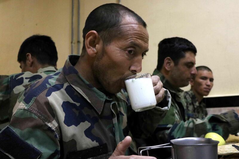 Afghan Army soldiers break the fast at their military base, during Ramadan, amid the coronavirus pandemic in Herat, Afghanistan, April 17. EPA