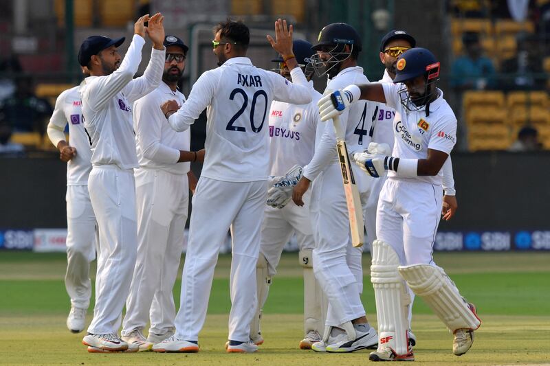 India's players celebrate after the dismissal of Sri Lanka's Charith Asalanka for five. AFP