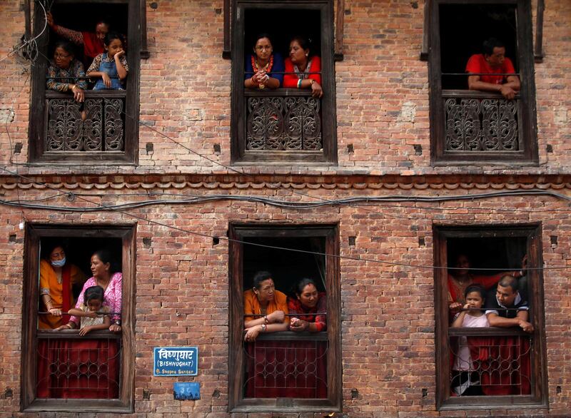 People observe the Nil Barahi mask dance festival, an annual event during which dancers perform while posing as various deities that people worship to seek blessings, in Bode, Nepal.  Reuters