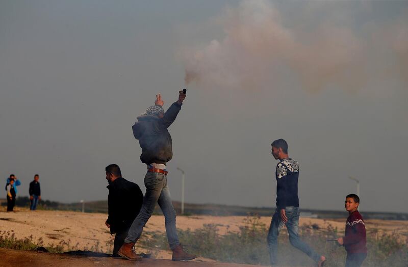 A Palestinian demonstrator holds a tear gas canister fired by Israeli troops during a protest at the Israeli-Gaza border fence, east of Gaza City on March 29, 2019. Reuters