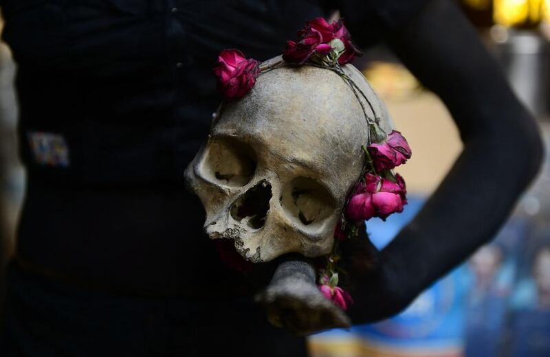 A Hindu devotee of the deity Shiva holds a human skull during a religious procession to mark the Hindu festival of Maha Shivratri in Allahabad.  Saniay Kanojia / AFP