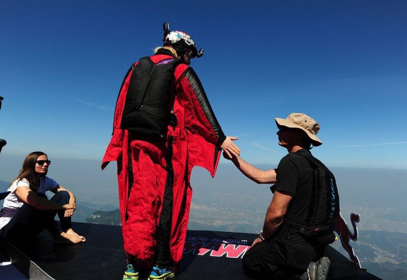 A competitor in a wingsuit prepares to jump from Tianmen Mountain during the wingsuit flying China Grand Prix on Friday. ChinaFotoPress / Getty Images