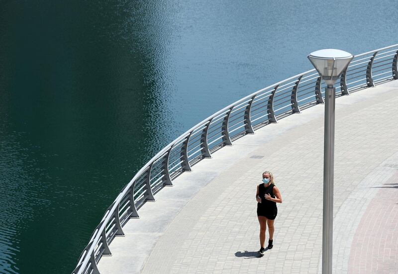 Dubai, United Arab Emirates - Reporter: N/A: Coronavirus. A lady exercises in the marina on the first morning where the government has eased restrictions on personal travel due to Covid-19. Friday, April 24th, 2020. Dubai. Chris Whiteoak / The National