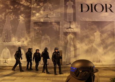 Police stand guard in front of the Dior building during riots after the death of Nahel. Reuters 