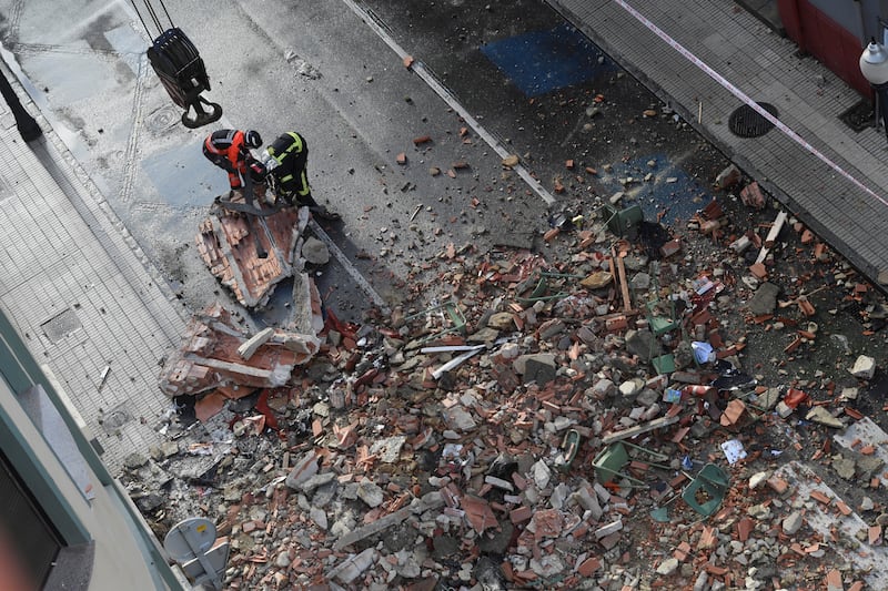 Emergency services personnel remove debris from the front of San Vicente Paul school in Gijon, Asturias region, northern Spain.  At least one person was killed when part of the roof collapsed. Two people were injured and one is missing. EPA