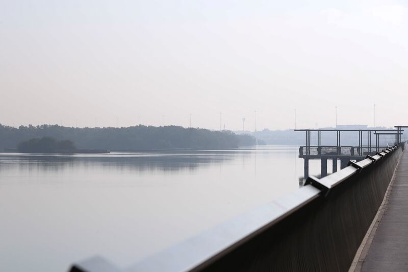 It was also a hazy morning along the Al Gurm Corniche in Abu Dhabi. Khushnum Bhandari / The National