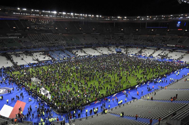 In this file photo spectators gather on the pitch of the Stade de France stadium after a series of gun attacks occurred across Paris in November 2015. AFP