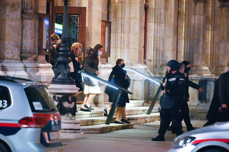 Austrian police guard a visitor while they leave The Wiener Staatsoper (Vienna State Opera) after a shooting near the Stadttempel synagogue in Vienna.  EPA