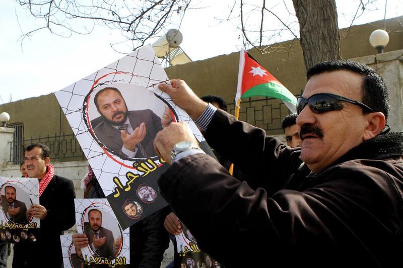 Muslim Brotherhood supporters outside the state security court in Amman on February 15. Raad Adayleh / AP 